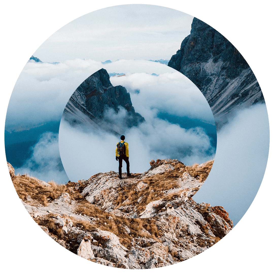 Man standing on mountain peak looking out