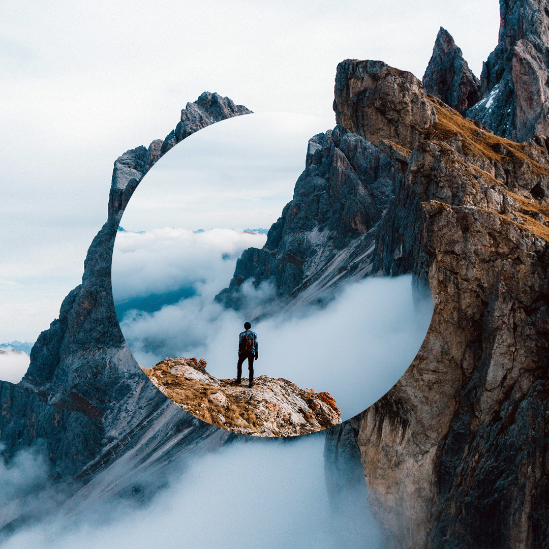 Man standing on cliff looking out
